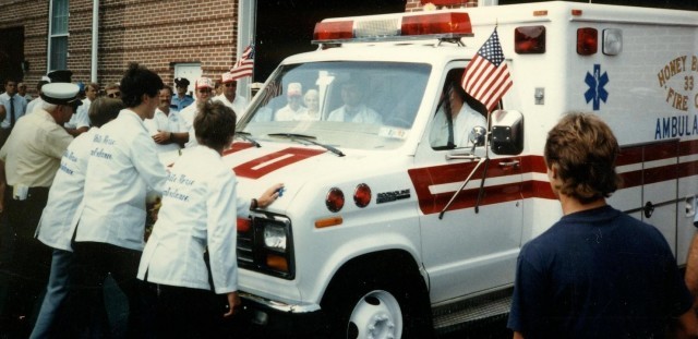 Chief Parmer (left) helping house the 1985 ambulance at Honey Brook in 1986.